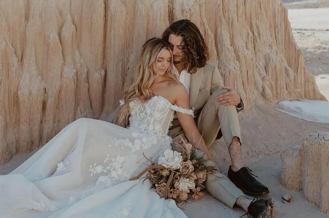 Сouple wearing a white gown and a gray suit